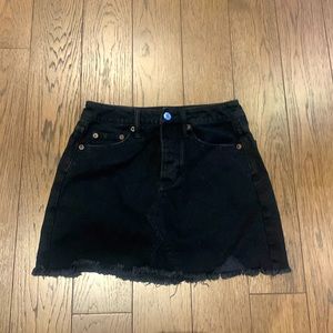 Black denim mini skirt. Button fly